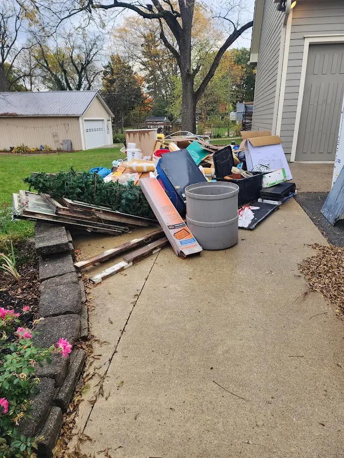 Dumpster being loaded with debris for Estate Cleanout Dumpster Rental in Williamsburg